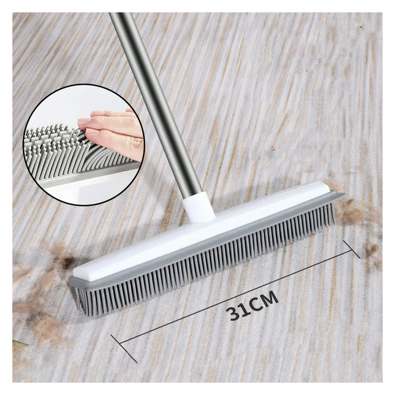 Rubber broom pulling pet hair off a rug
