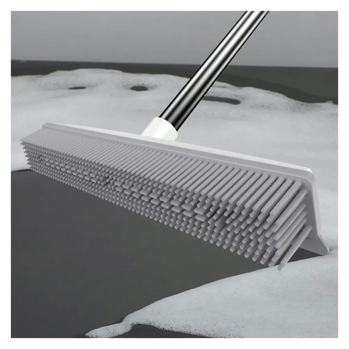 Squeegee edge pushing water on a hard floor